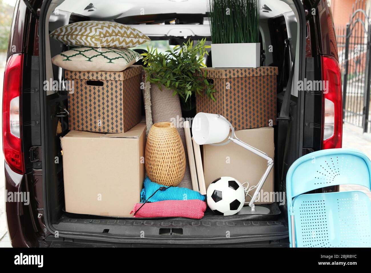 Cardboard boxes in car trunk on moving day Stock Photo - Alamy