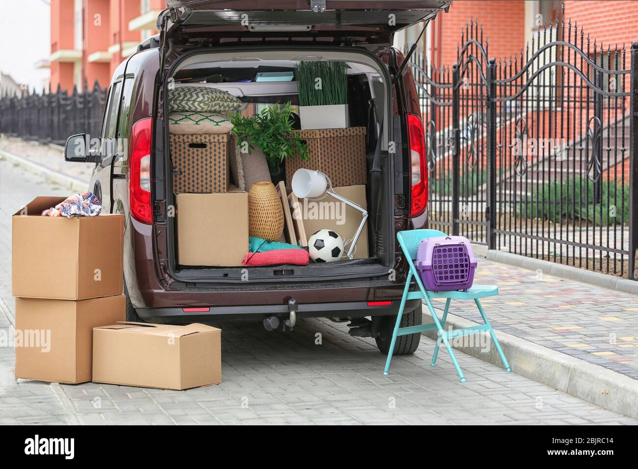 Cardboard boxes in car trunk on moving day Stock Photo - Alamy