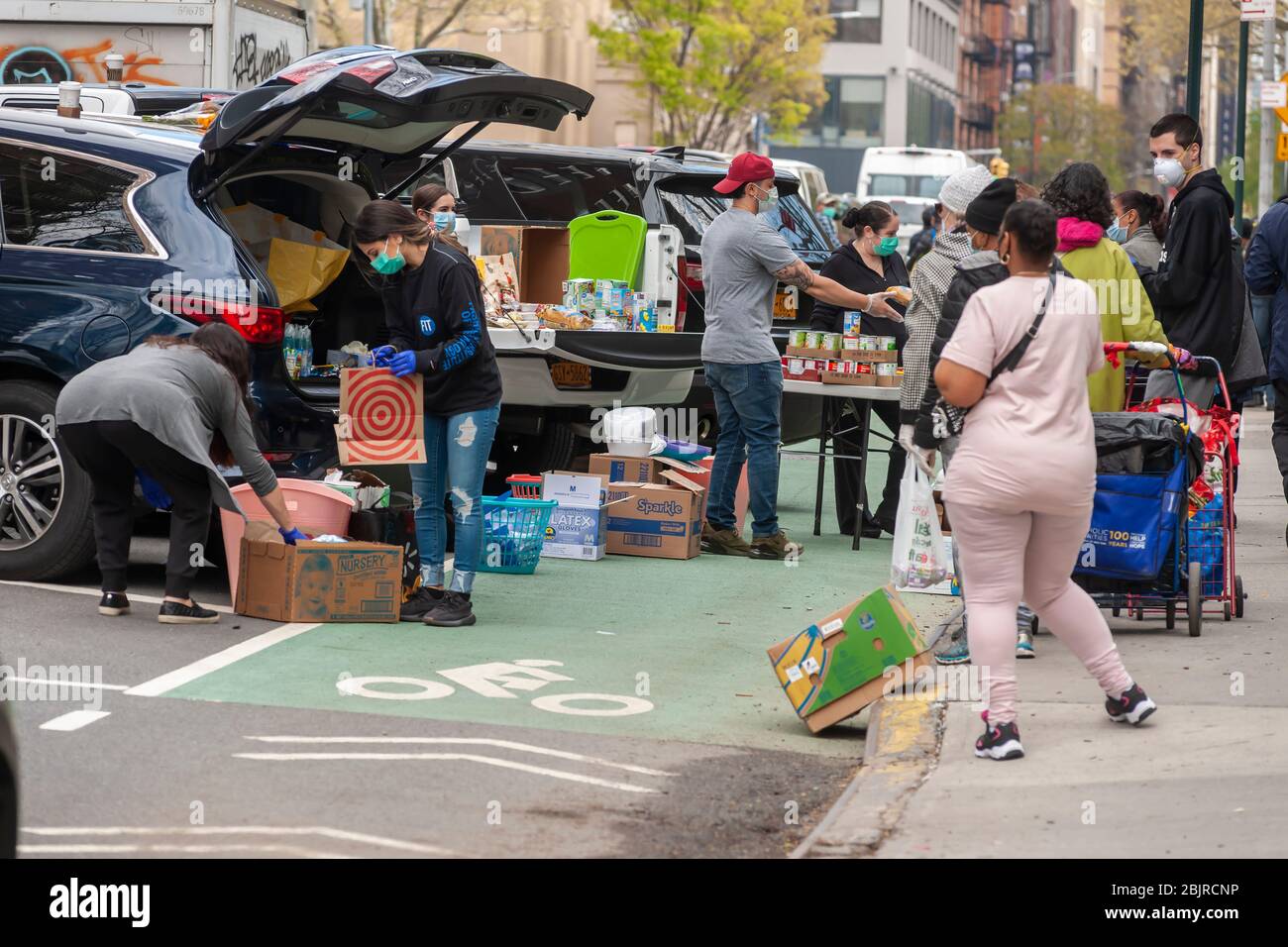 Evangelical volunteers in Chelsea in New York distribute food on Saturday, April 25, 2020. With 26 million people applying for unemployment food pantries have become a lifeline for many.  (© Richard B. Levine) Stock Photo