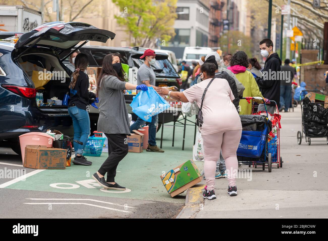 Evangelical volunteers in Chelsea in New York distribute food on Saturday, April 25, 2020. With 26 million people applying for unemployment food pantries have become a lifeline for many.  (© Richard B. Levine) Stock Photo