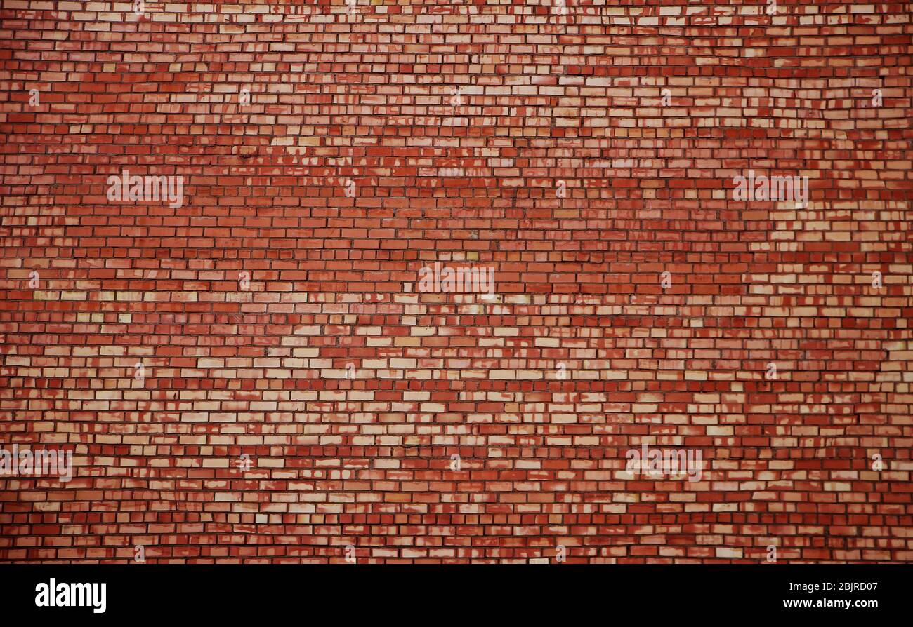 Weathered stained old red brick wall background Stock Photo