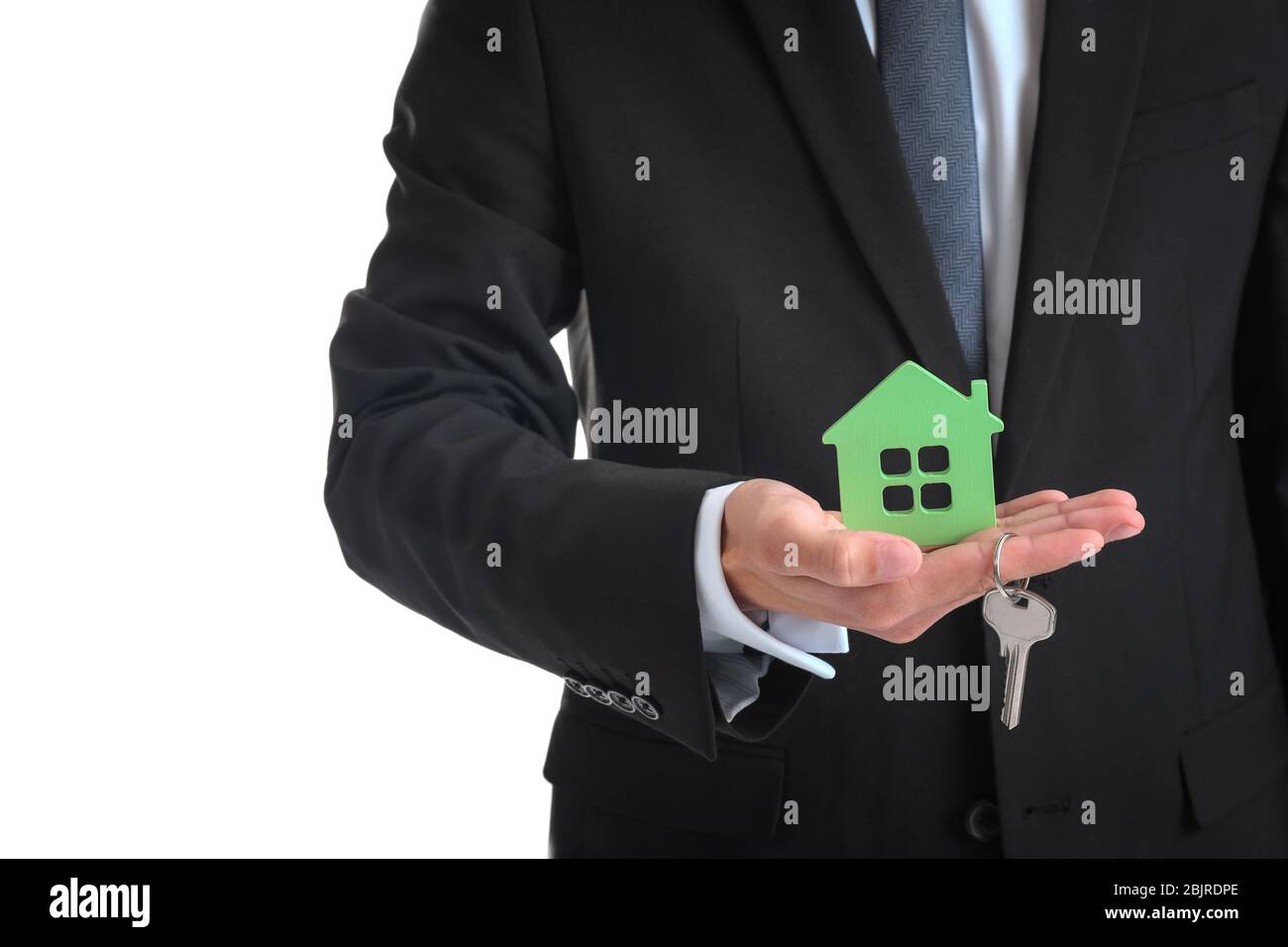 Real estate agent holding house model and key on white background Stock ...