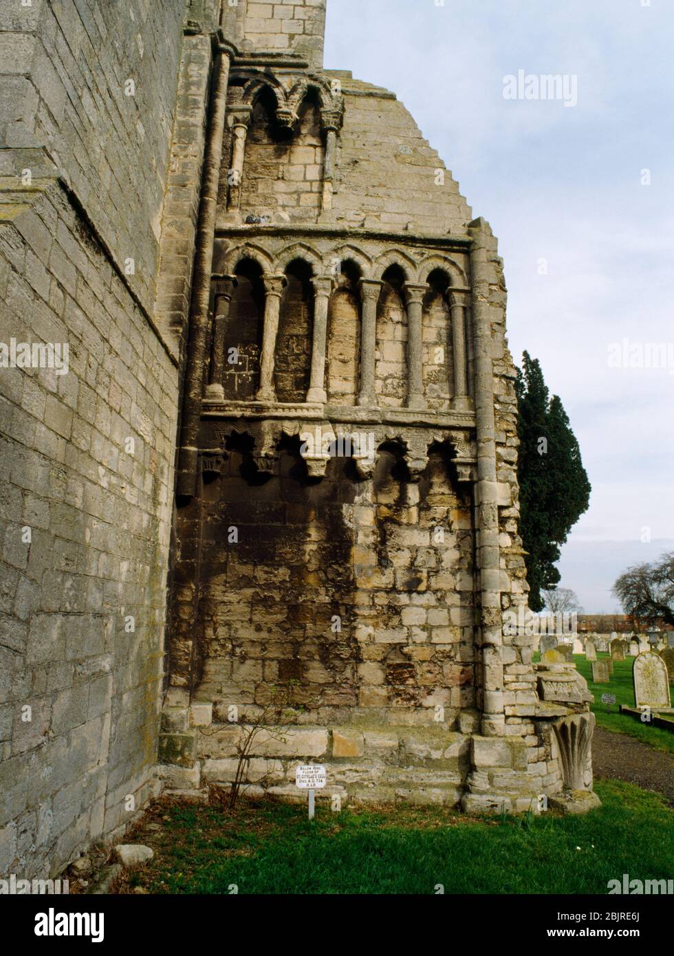 View E of the site of St Guthlac's cell outside the S aisle of the ruined nave of Croyland Abbey church, Lincolnshire, England, UK. Norman arcading. Stock Photo