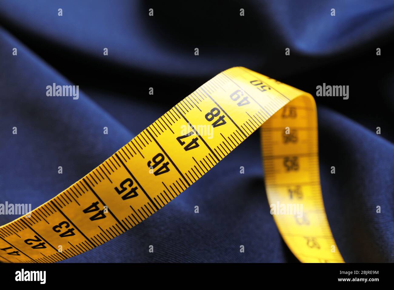 Measuring tape on fabric, closeup Stock Photo Alamy