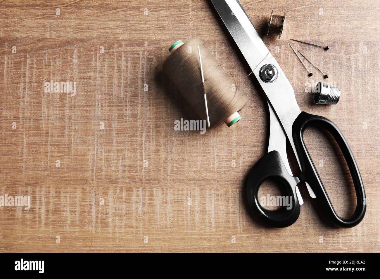Set of tailoring tools and accessories on wooden table, top view Stock ...