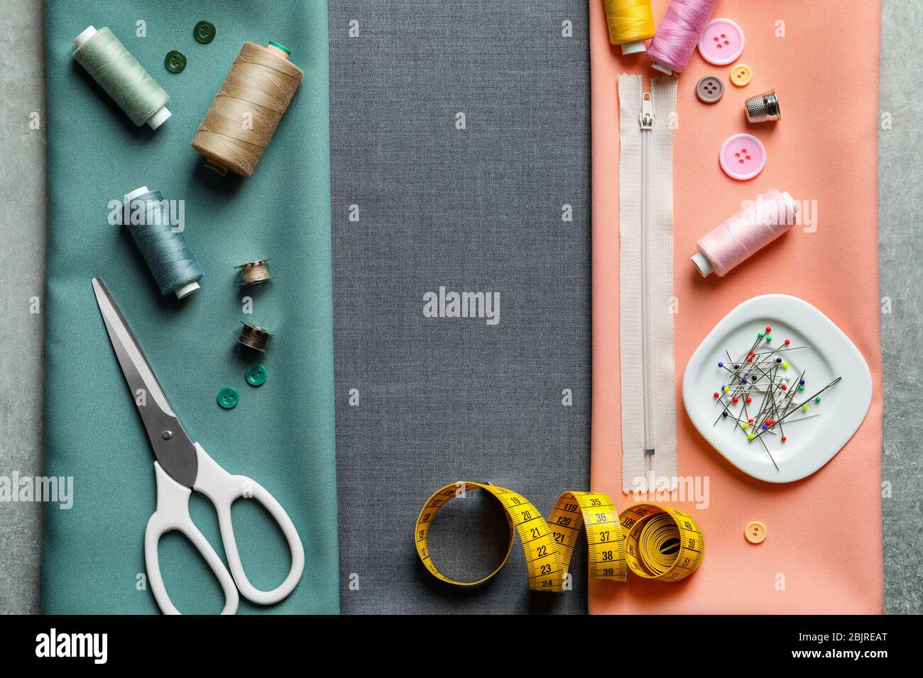 Set of tailoring tools and accessories on fabric, top view Stock Photo ...