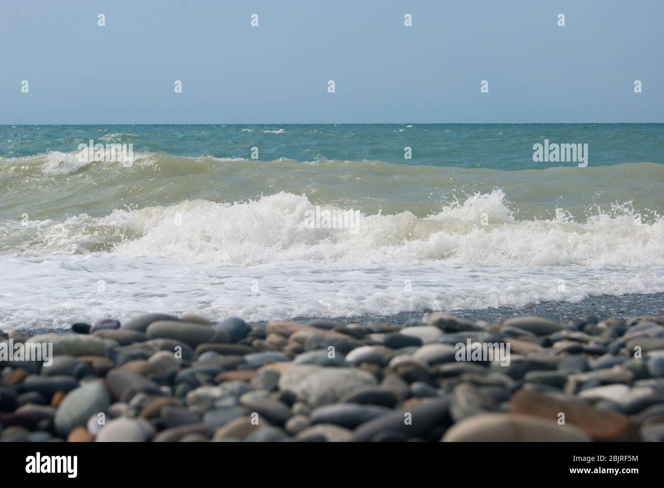 The Sea Wave of the Black Sea is a pebble beach. Smooth horizon, blue sky. Vacation vacation vacation summer happiness appeasement Stock Photo