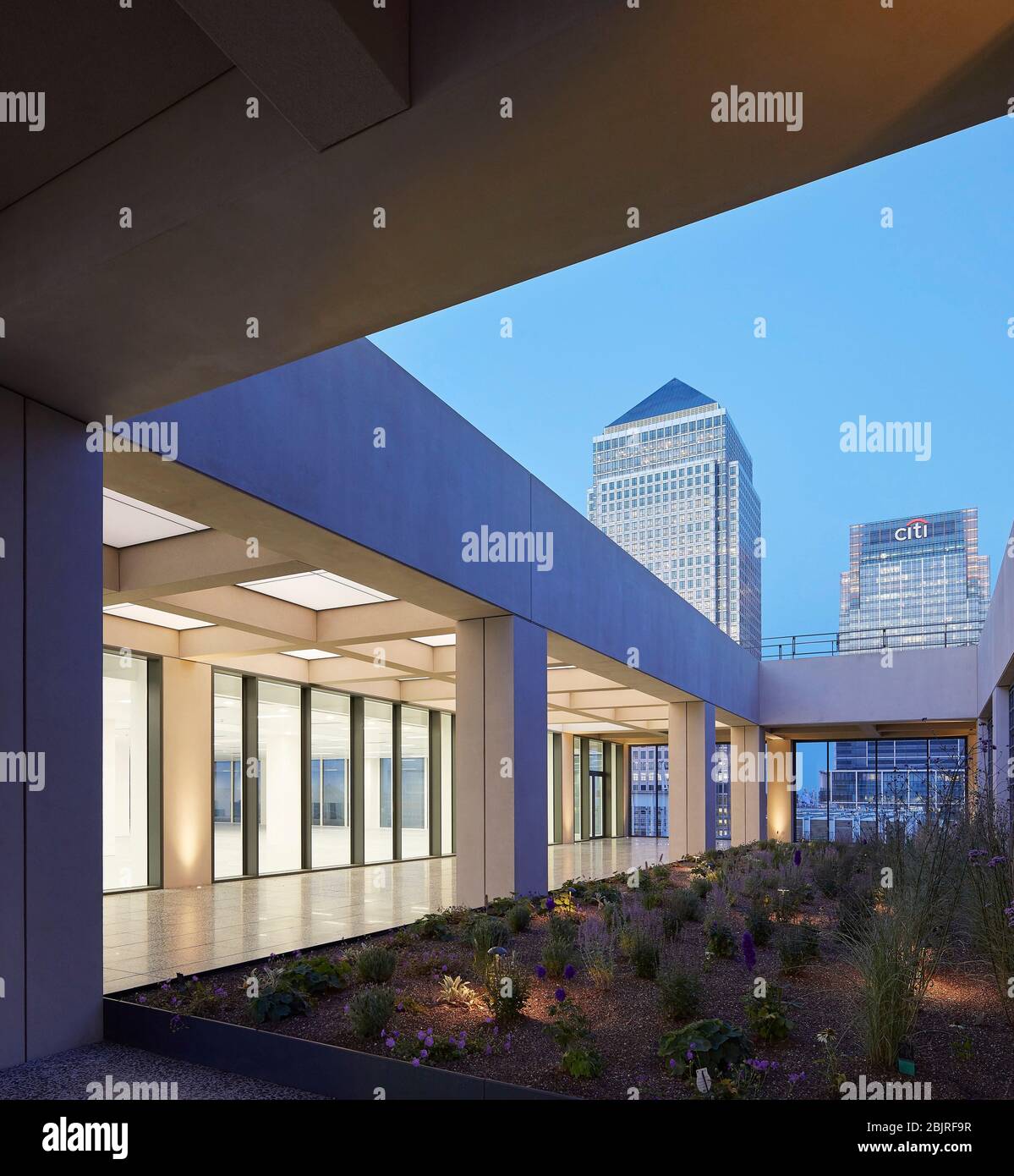 Upper level outdoor terrace with garden at dusk with 1 Canada Square