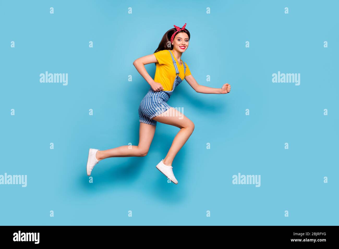 Full length body size view of her she nice attractive lovely cheerful cheery energetic girl jumping running fast isolated over bright vivid shine Stock Photo