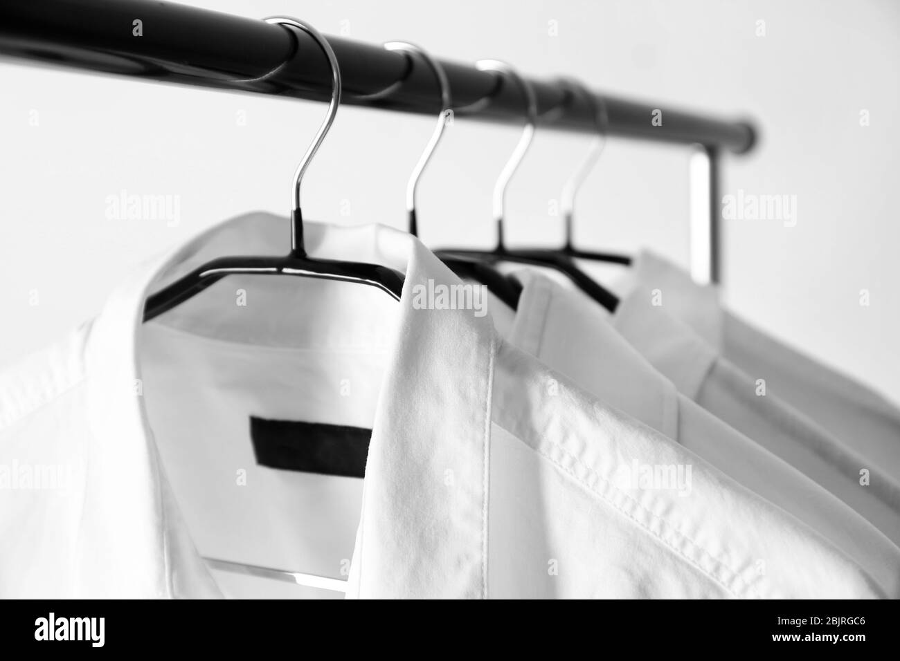 Hangers with clean shirts in laundry, closeup Stock Photo Alamy