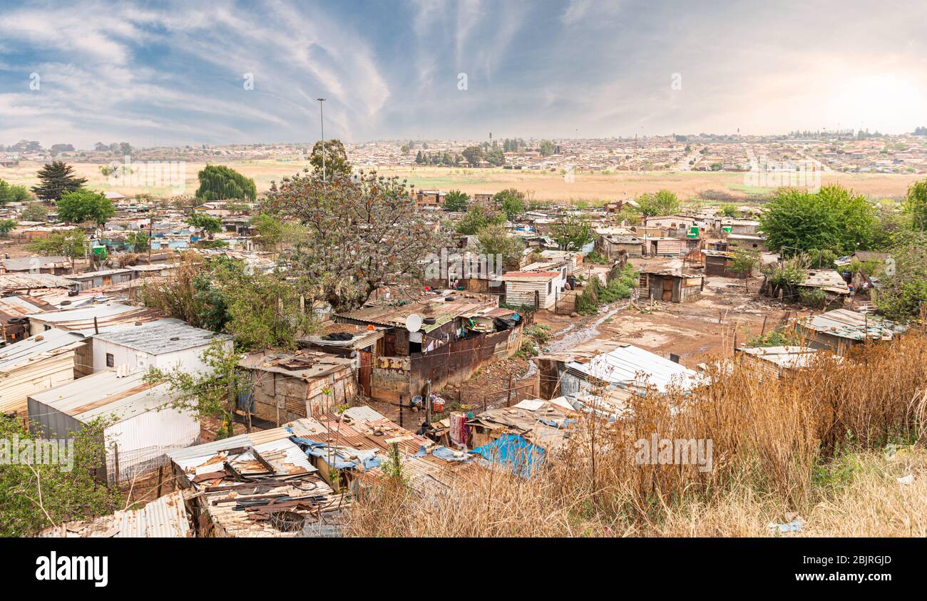 Poor townships next to Johannesburg, South Africa, with a dramatic sky