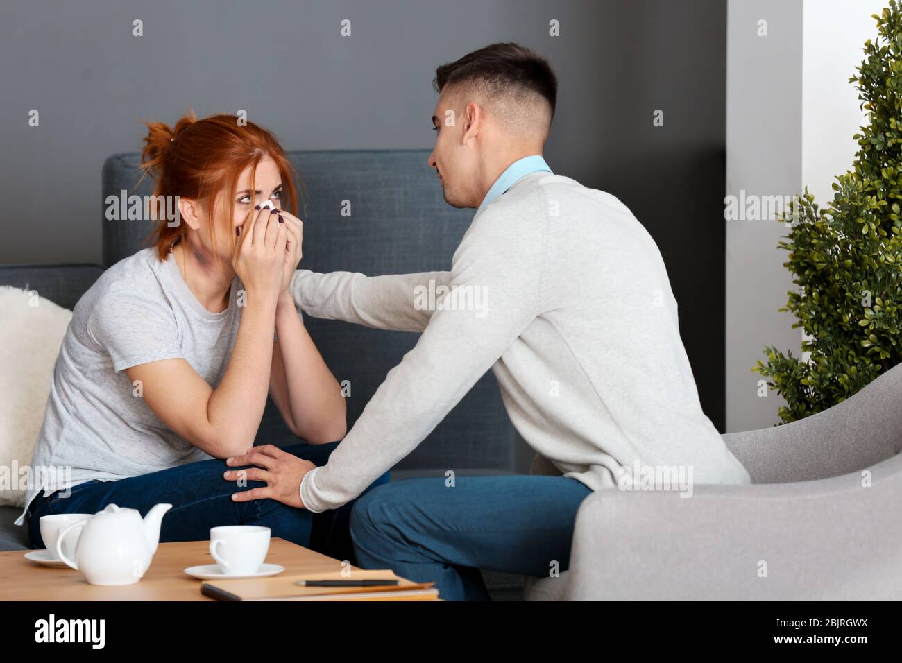 Professional psychologist comforting crying hi-res stock photography ...