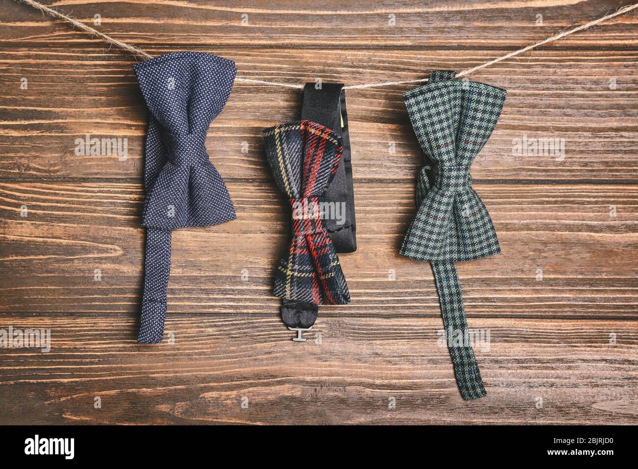 Happy Father's Day concept. Bow ties hanging on rope against wooden ...