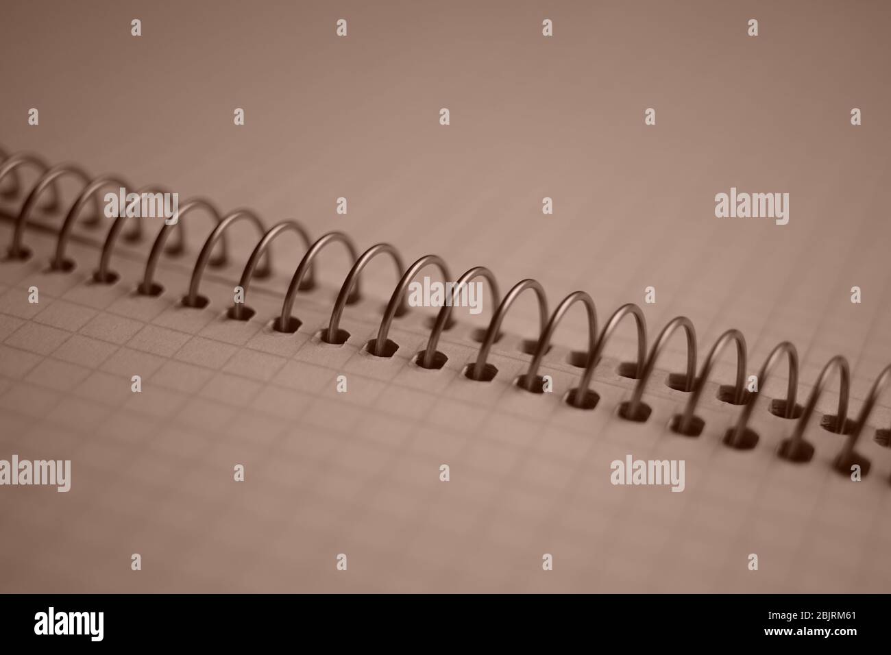 open notebook on a spiral, squared paper closeup. Stock Photo