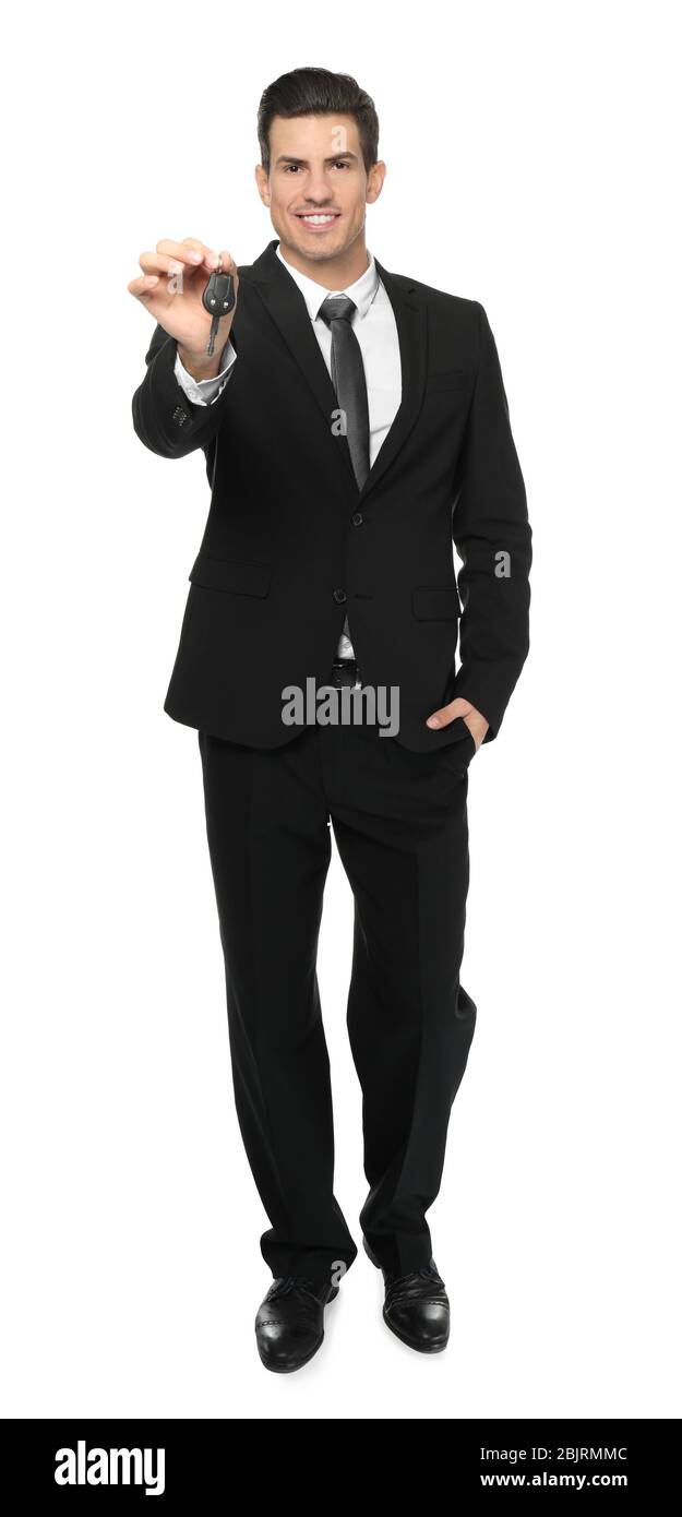 Salesman in formal suit holding car key on white background Stock Photo ...