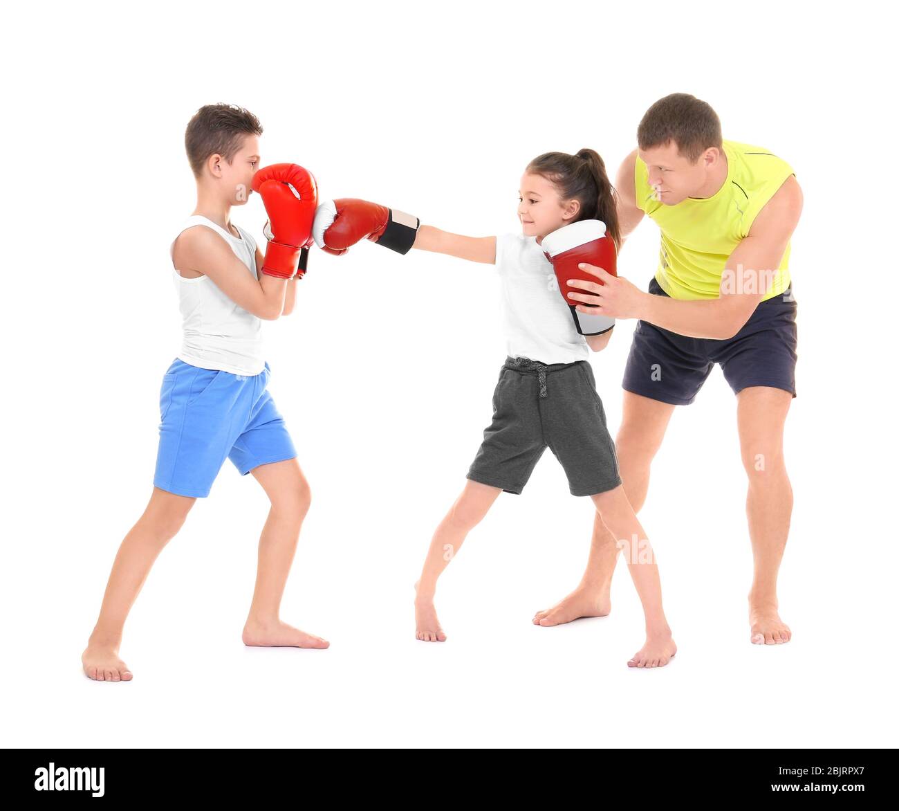 Cute little children training with boxing coach on white background ...