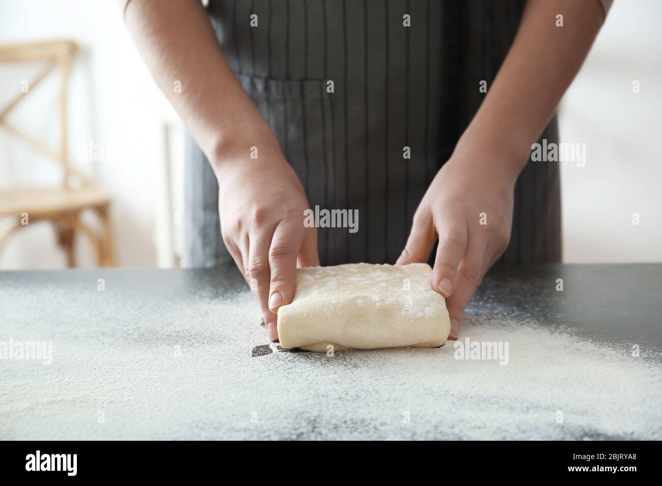 Woman kneading dough on table, closeup Stock Photo - Alamy