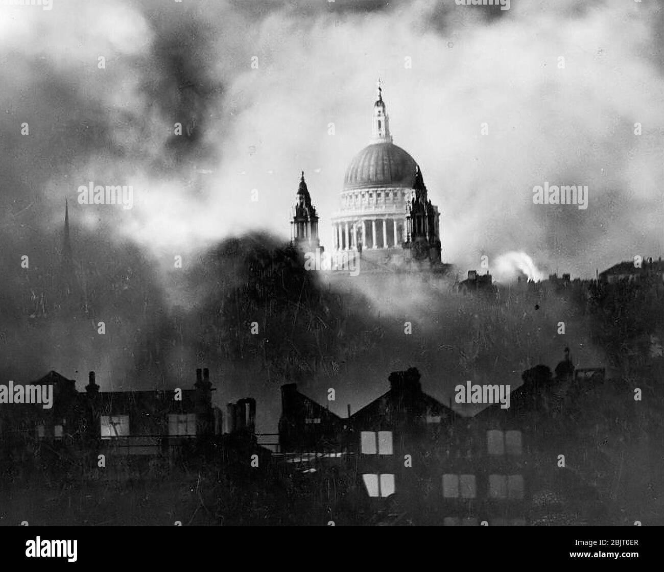Air Raid Damage in Britain during the Second World War St Paul's Cathedral, rising above the bombed London skyline, is shrouded in smoke during the Blitz. The photograph was taken from the roof of the Daily Mail offices in Fleet Street. Stock Photo