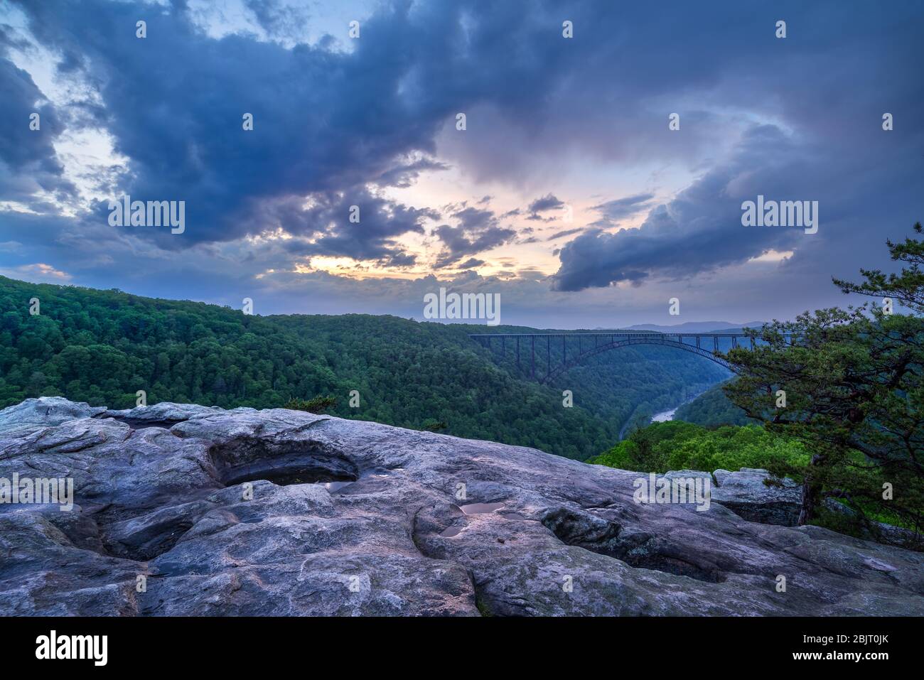 Spring storms sweep over the New River Gorge of West Virginia leaving dramatic, moody sunset skies as viewed from the Long Point overlook. Stock Photo