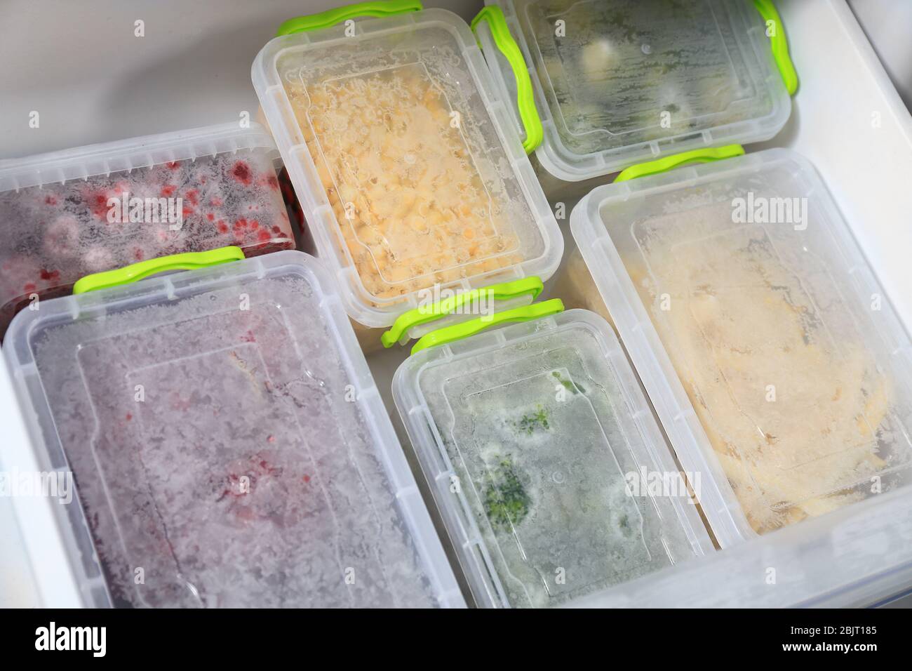 Containers with different food in refrigerator Stock Photo