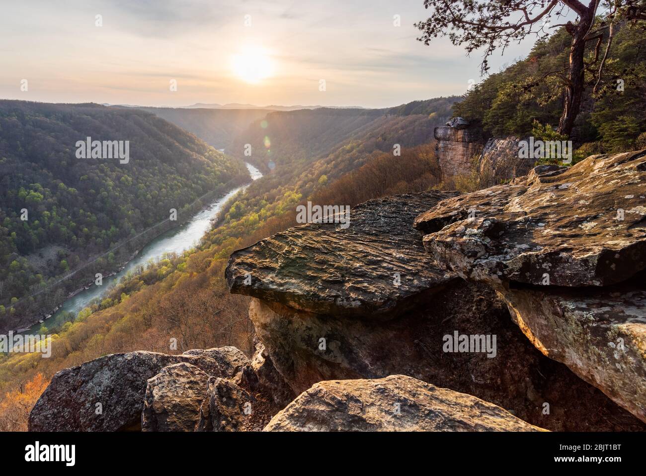 The sunsets on Beauty Mountain along the rocky clifflines of the New River Gorge in West Virginia on an early spring evening. Stock Photo