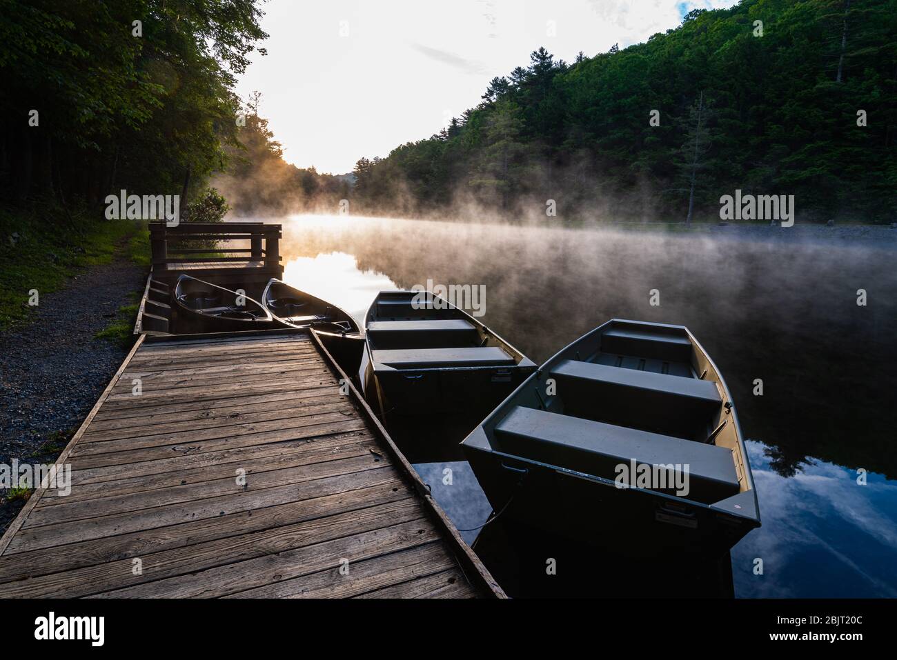 From the boat docks, the sun rises above a foggy Seneca Lake. Stock Photo