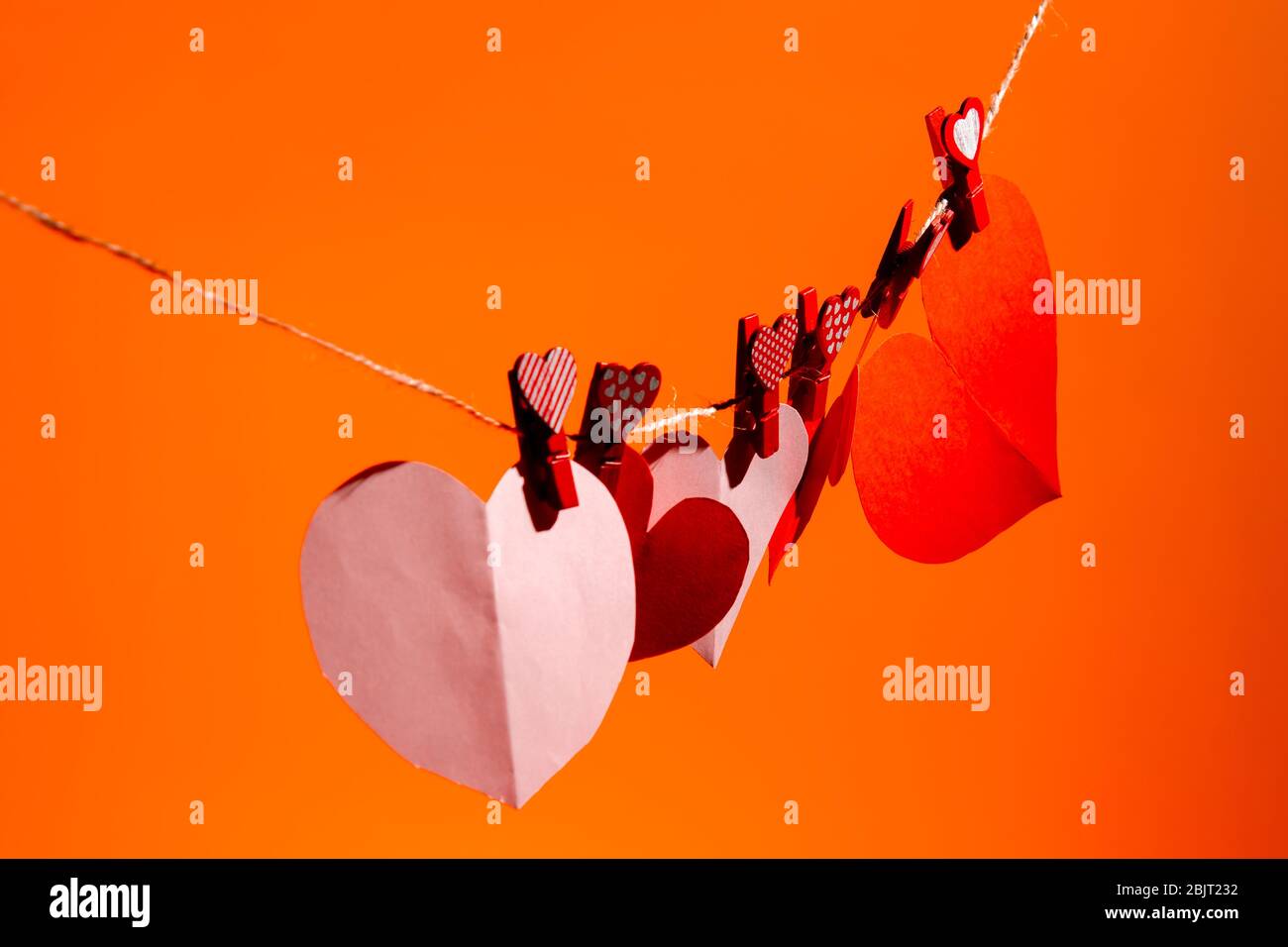 Paper hearts of red clothespins with a heart on a rope. Valentine's Day ...