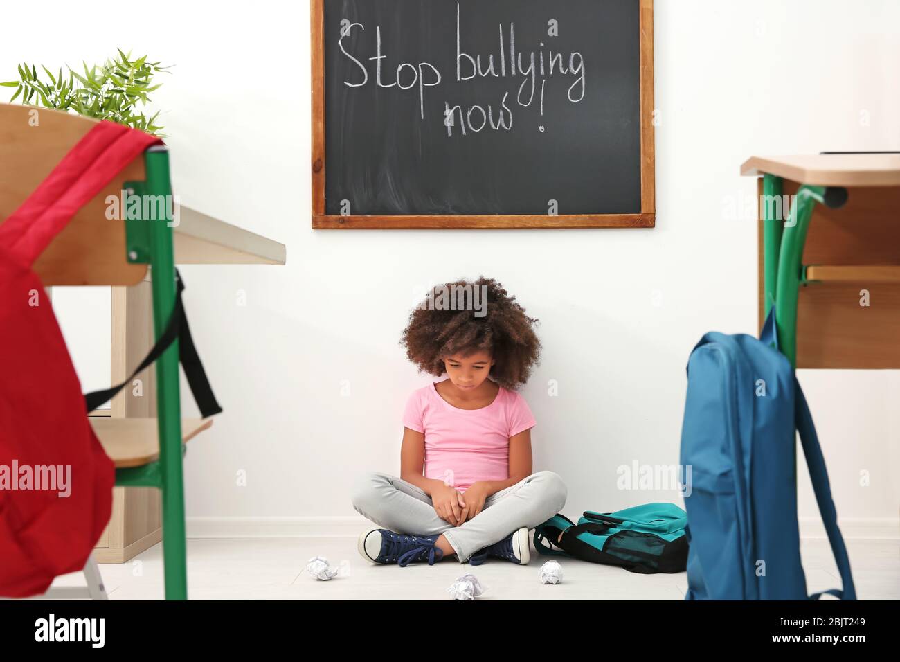Sad girl sitting in classroom hi-res stock photography and images - Alamy