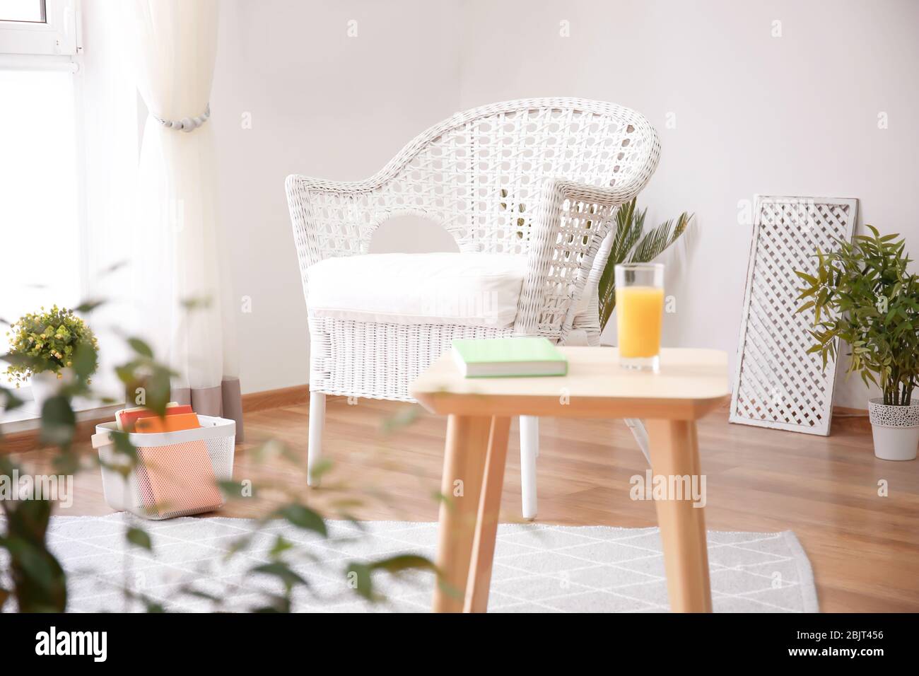 Elegant living room interior with white armchair Stock Photo - Alamy