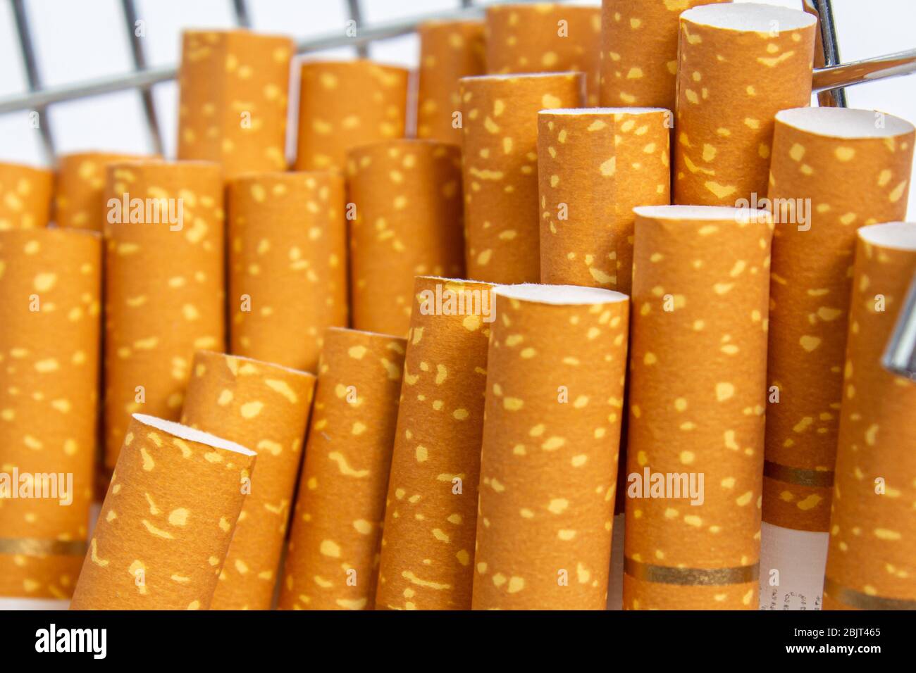 cigarette filters from orange cigarettes with a gold ribbon Stock Photo