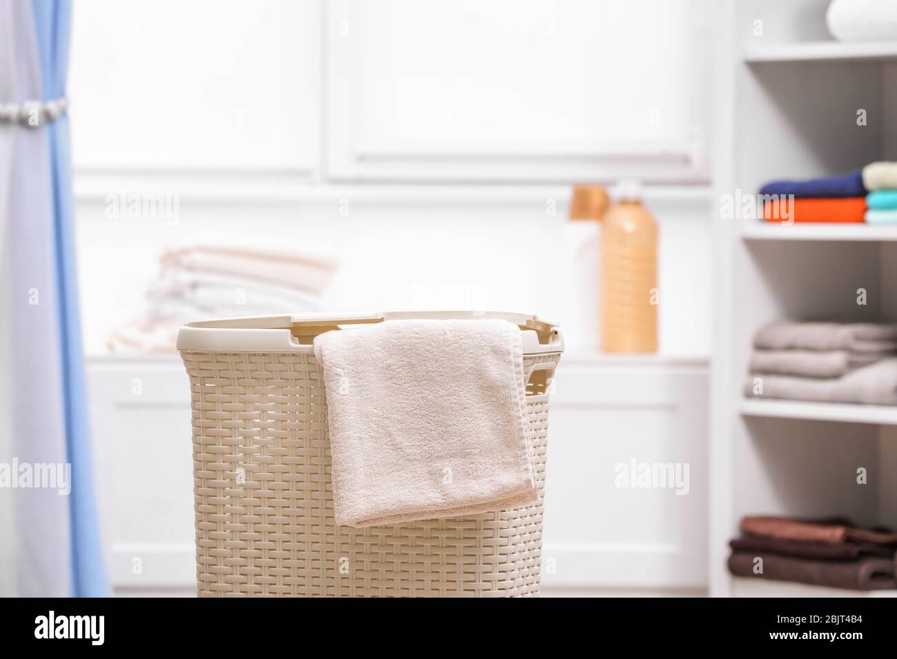 Plastic laundry basket with towel indoors Stock Photo Alamy
