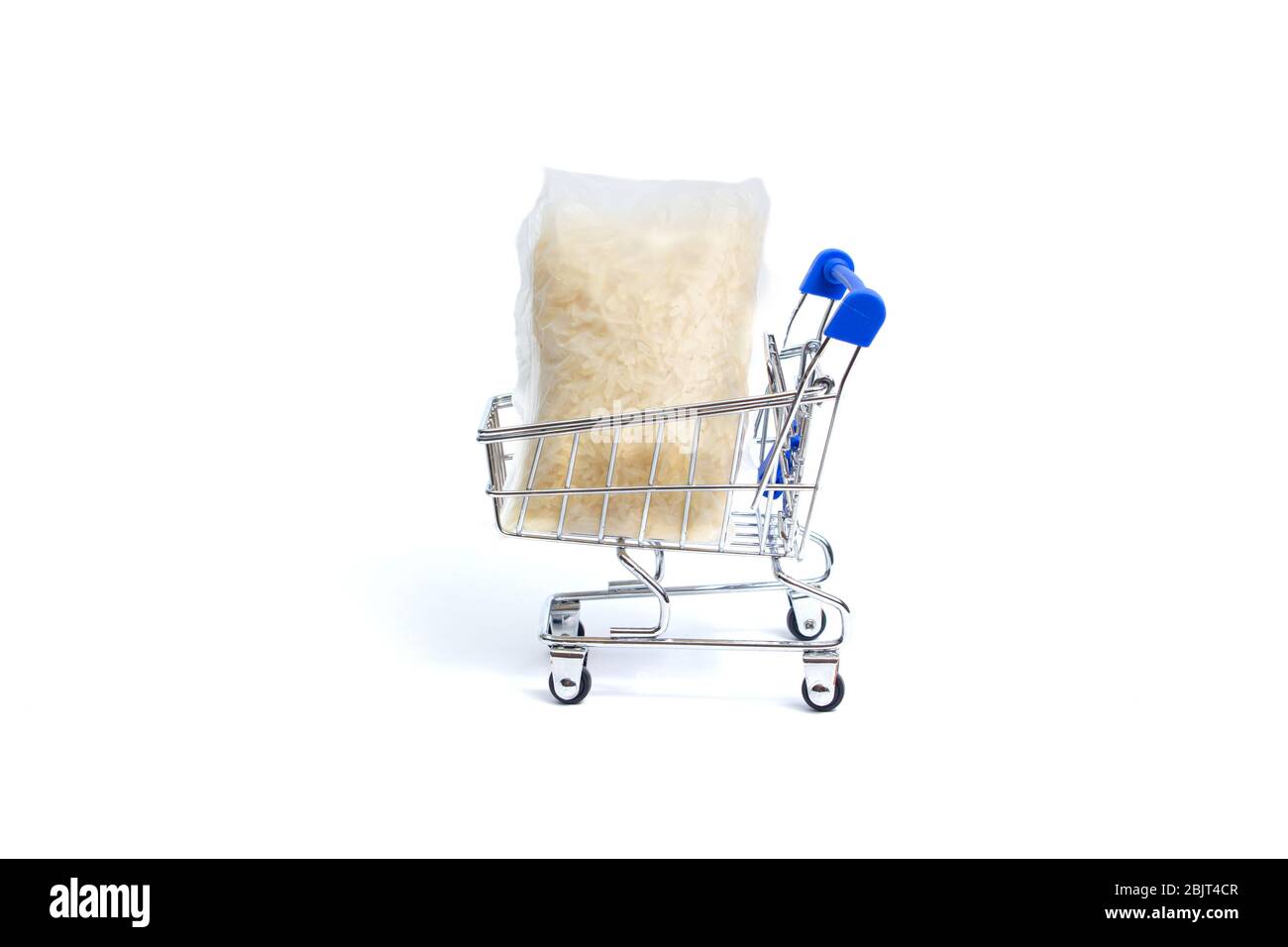 shopping cart lies two bags of rice on a white background. isolate Stock Photo