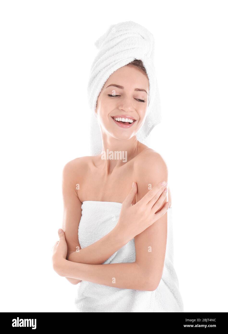 Attractive young woman in towel on white background Stock Photo - Alamy