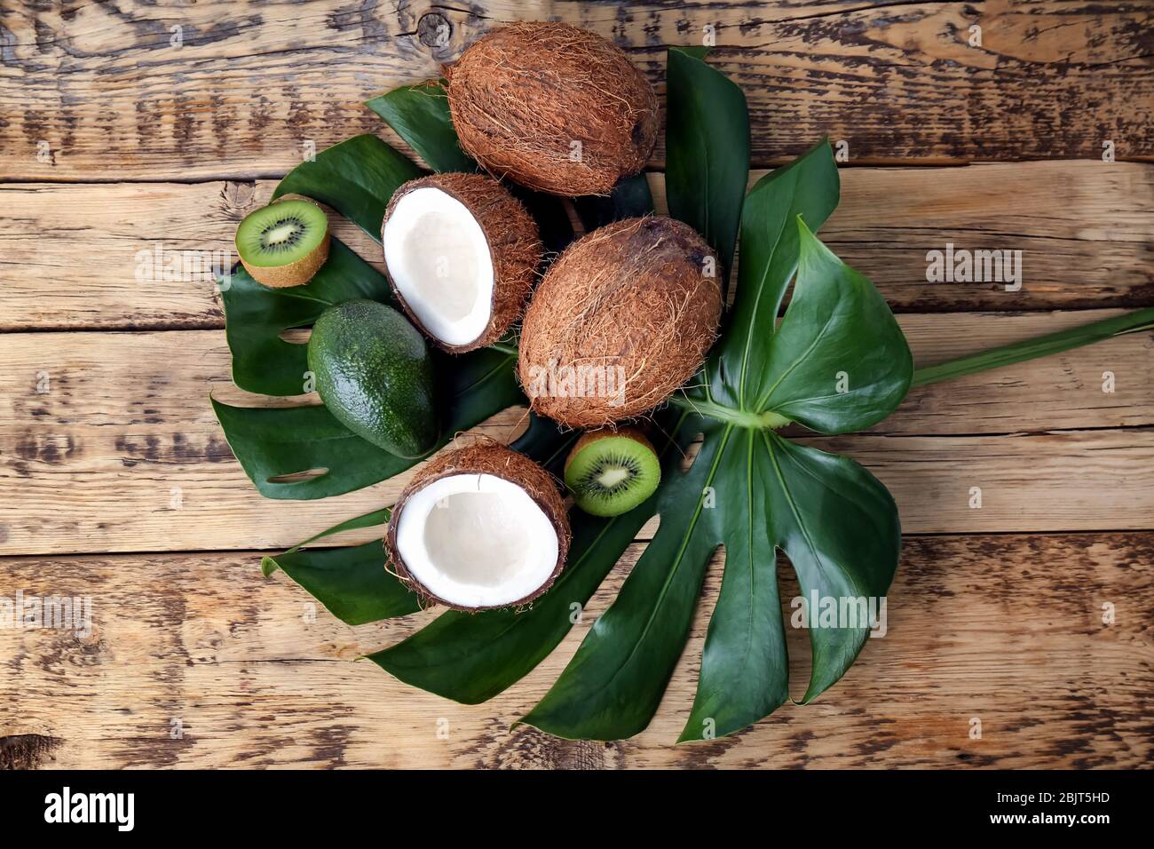 Composition with fresh coconuts and tropical fruits on green leaf Stock ...