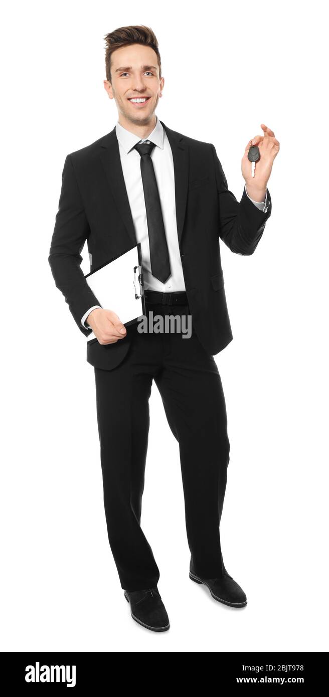 Young salesman holding car key on white background Stock Photo - Alamy