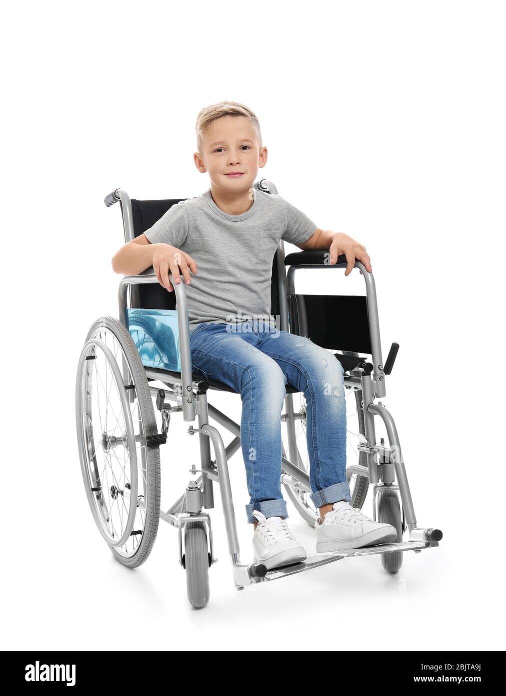 Little boy in wheelchair on white background Stock Photo