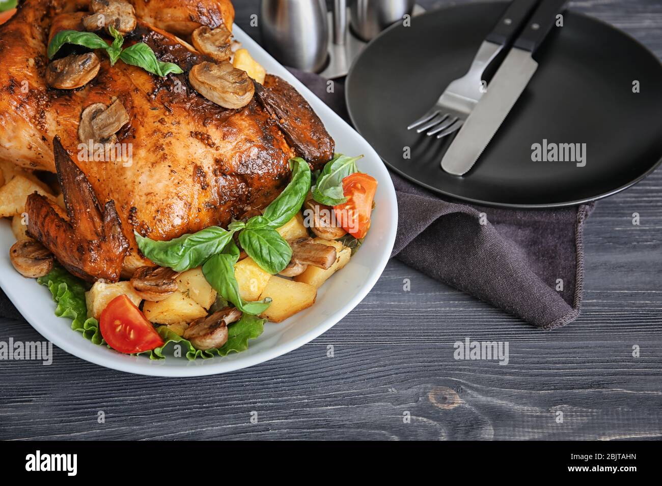 Chicken Tavolo Delicious whole roasted chicken served on wooden table Stock Photo - Alamy