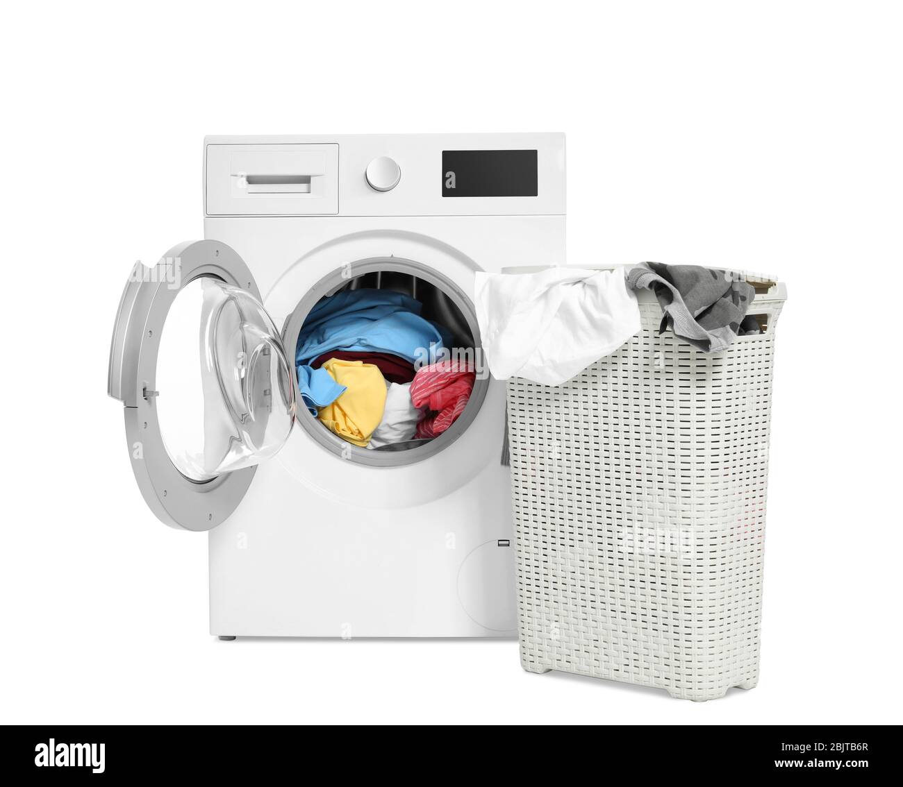 Washing machine and basket with laundry on white background Stock Photo