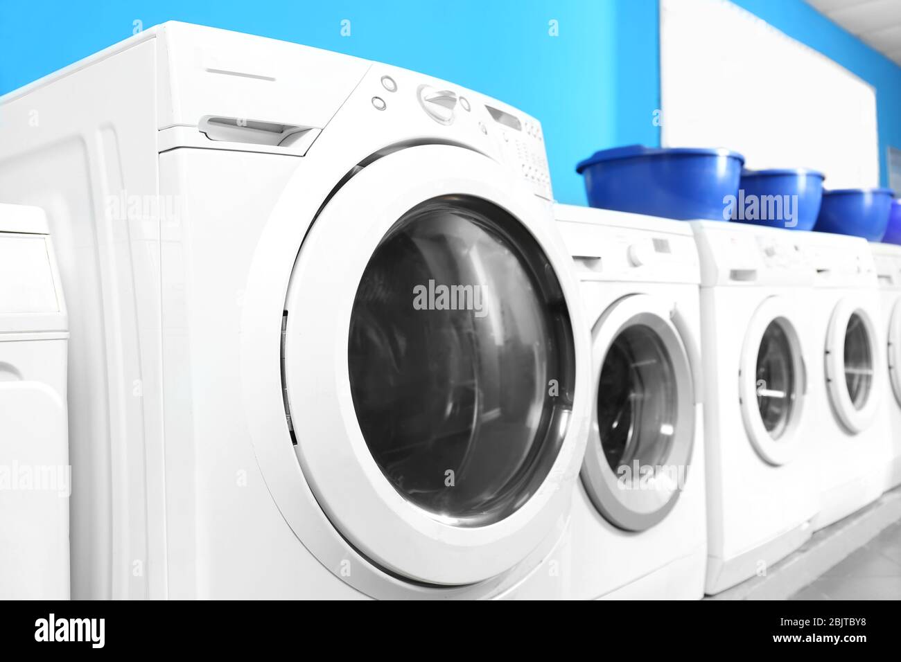 Industrial laundry machines in laundromat Stock Photo Alamy
