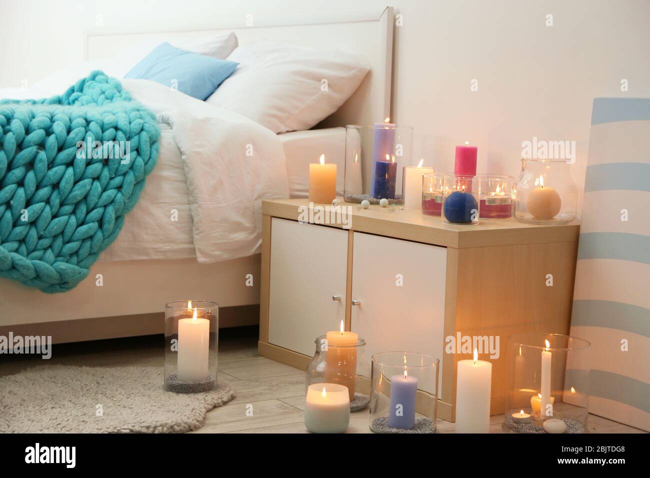 Cozy bedroom decorated with burning candles Stock Photo Alamy