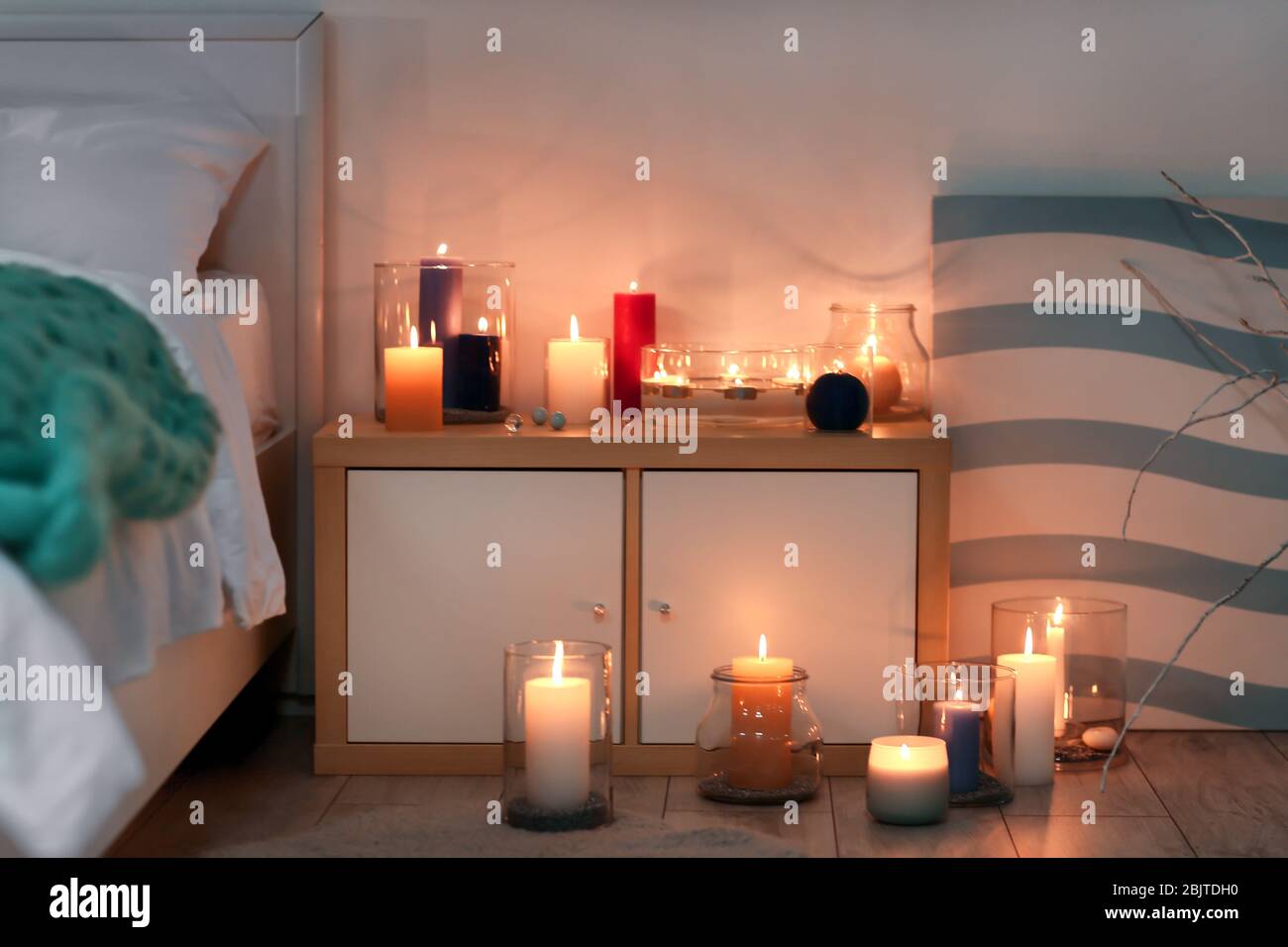 Cozy bedroom decorated with burning candles Stock Photo Alamy