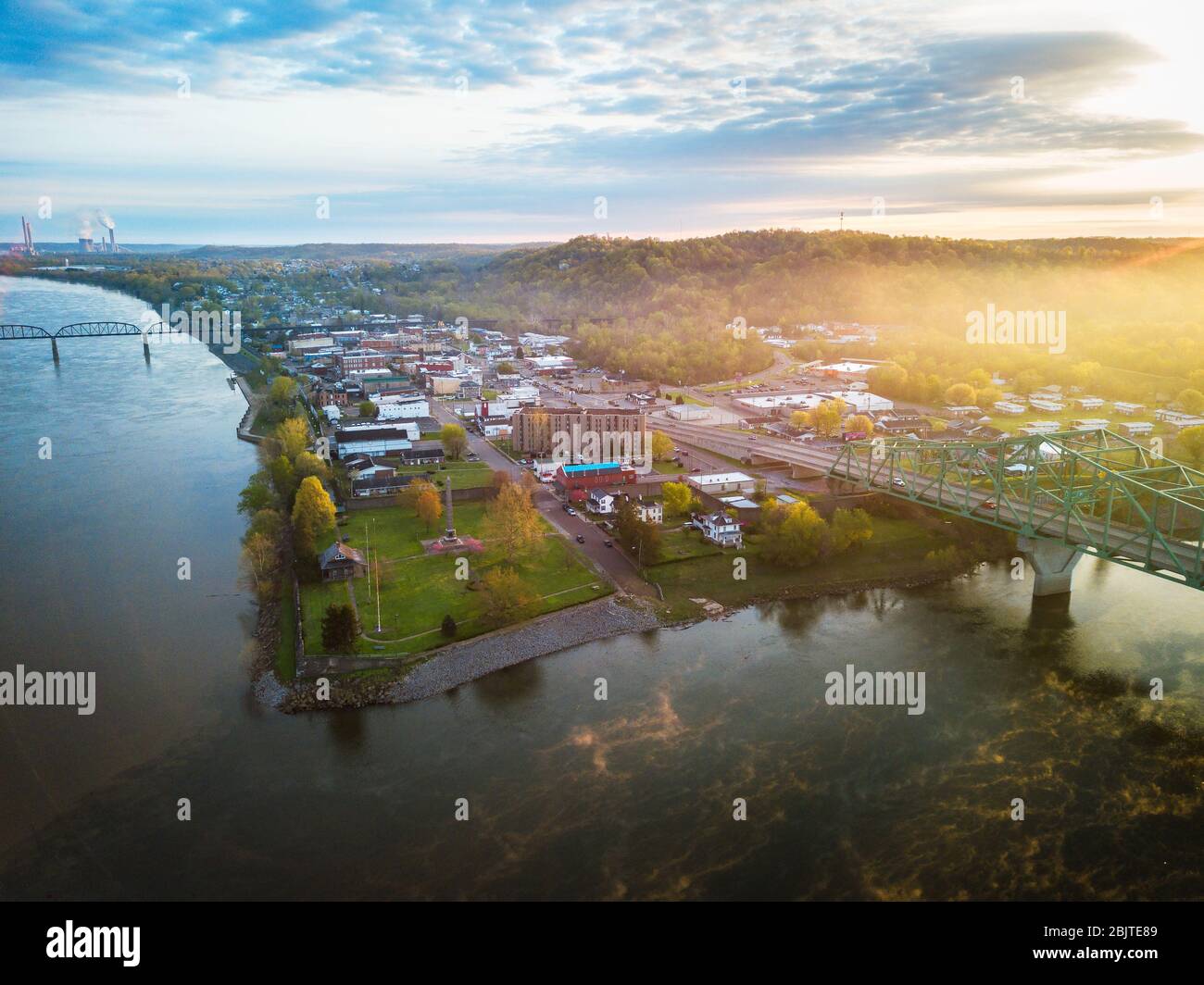 The rising sun casts its glow over the town of Point Pleasant West Virginia viewed from up high where the two rivers of the Kanawha and Ohio meet. Stock Photo