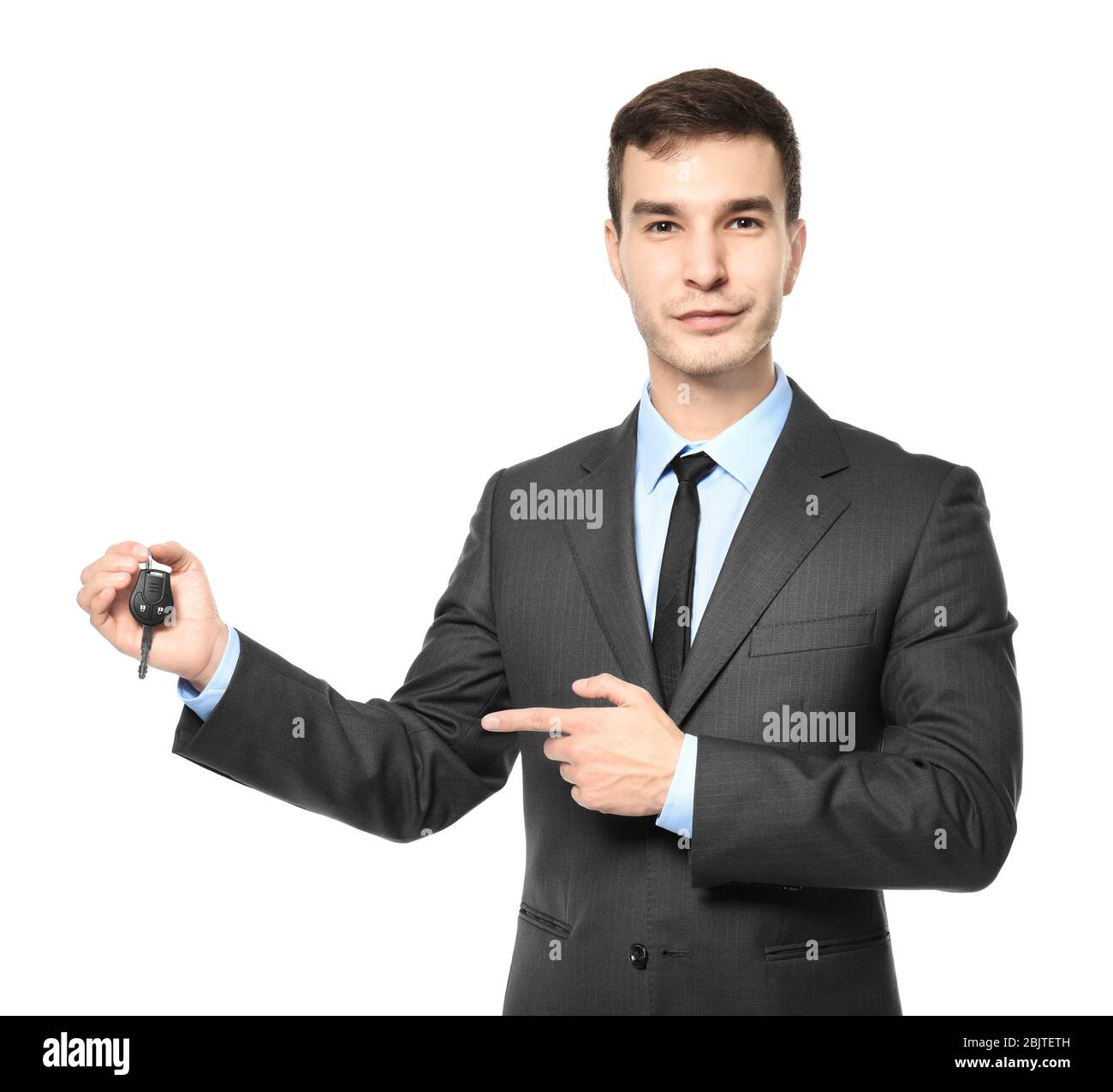 Handsome car salesman with key on white background Stock Photo - Alamy