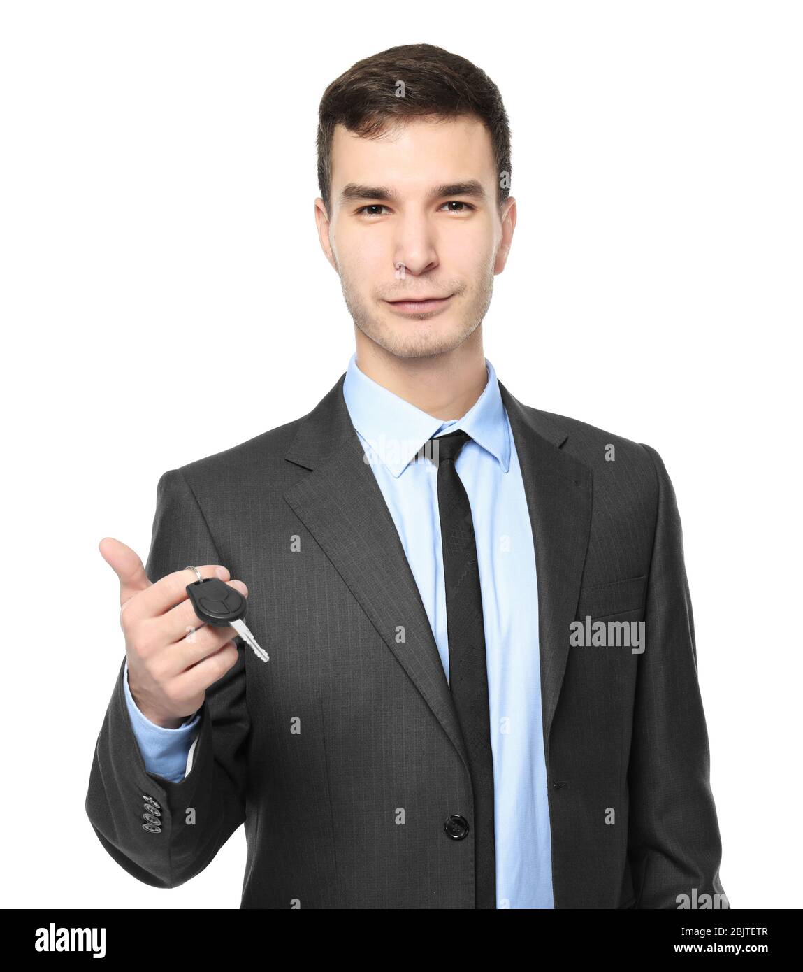 Handsome car salesman with key on white background Stock Photo - Alamy