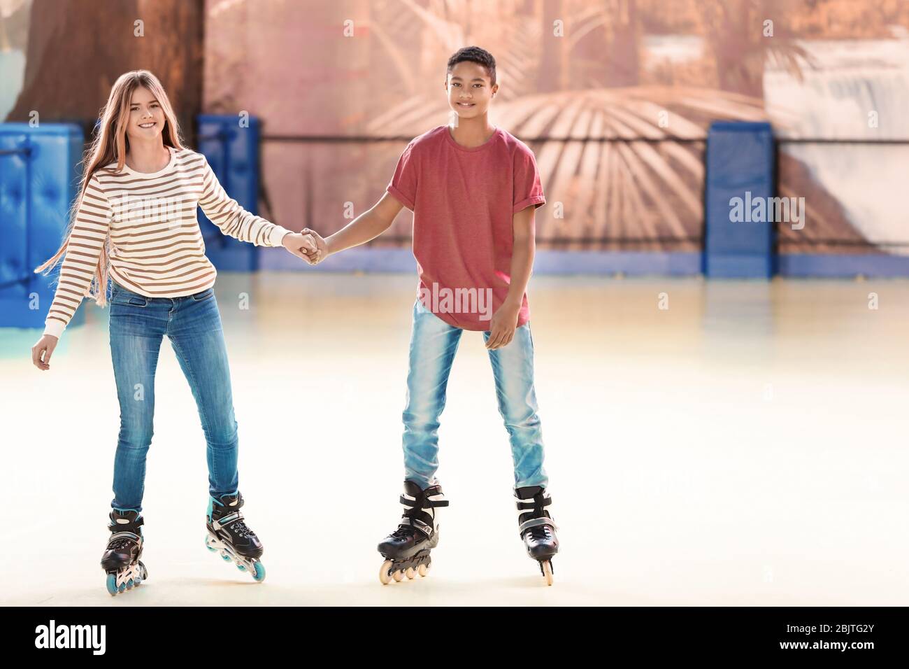 Cute teenage couple at roller skating rink Stock Photo Alamy