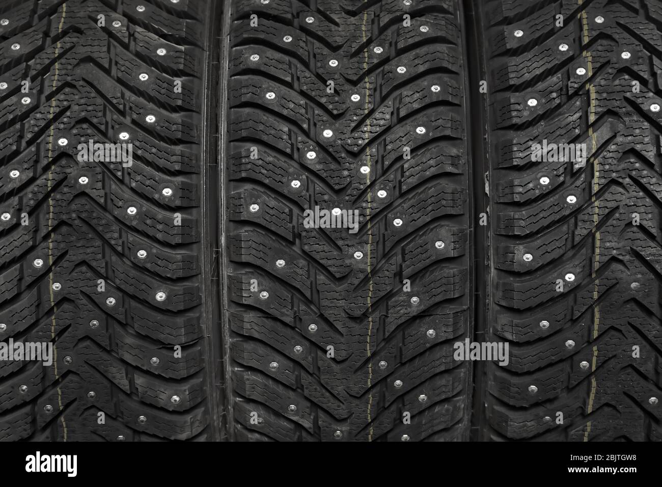 Closeup view of car tires with metal studs Stock Photo