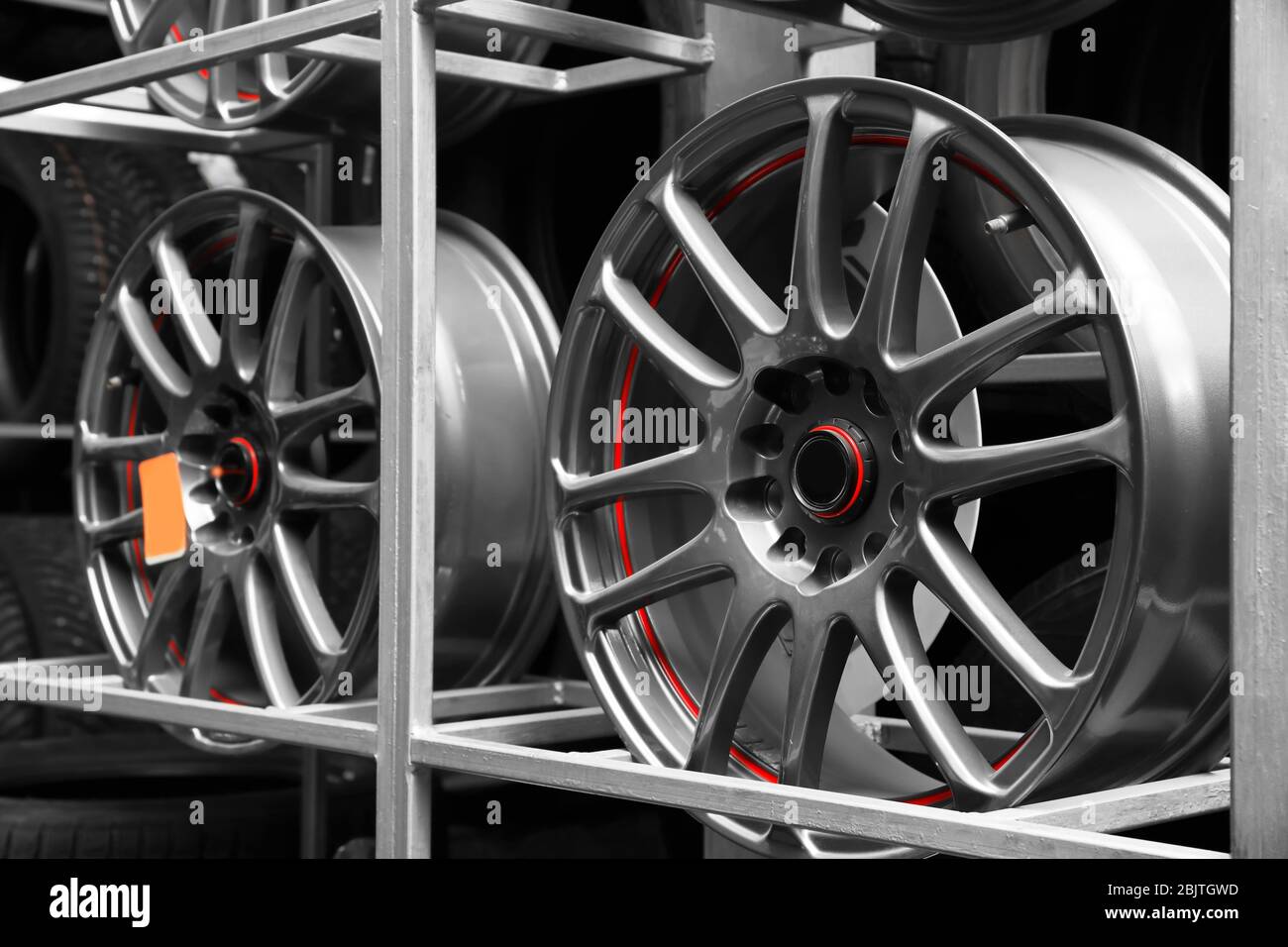 Rack with car wheels in automobile store Stock Photo - Alamy