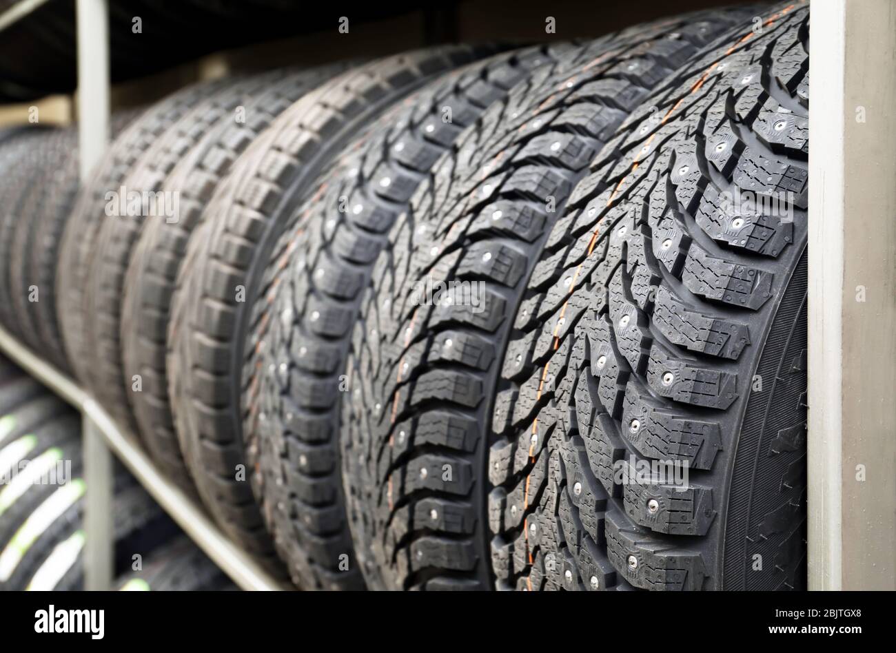 Rack with variety of car tires in automobile store Stock Photo