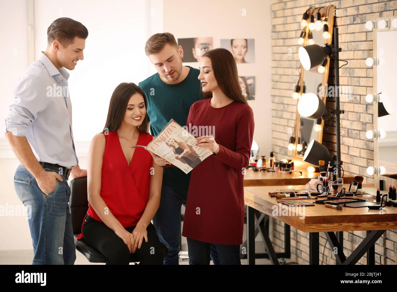 Professional makeup artist teaching trainees in salon. Apprenticeship