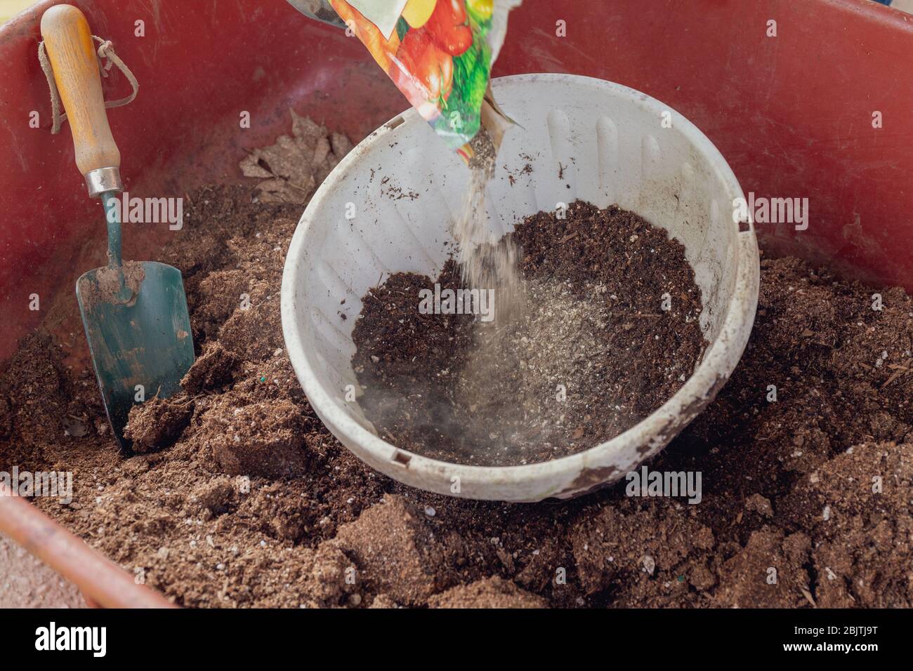 Mixing Soil and Fertilizer in Wheelbarrow for Gardening Stock Photo Alamy